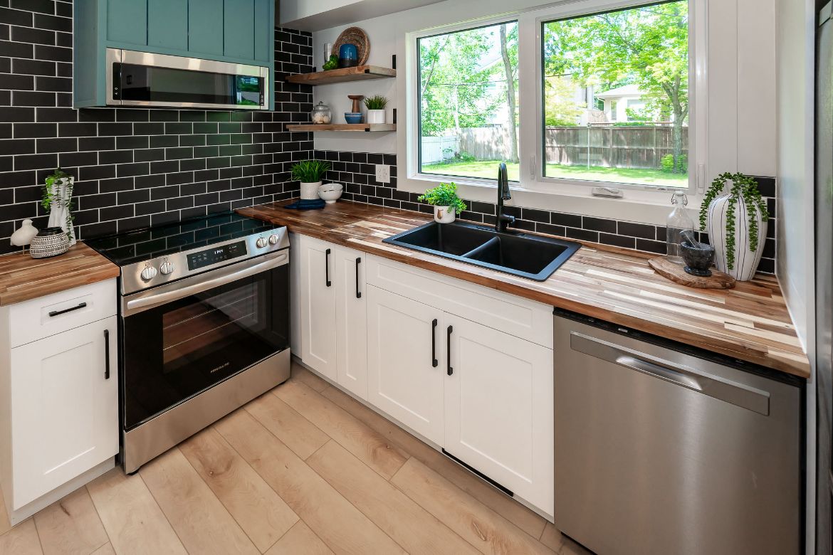 Kitchen with butcher-block counters and a window over the sink